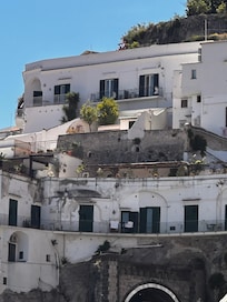 the top residence is Villa Torricelli (two balconies —on the left and middle)