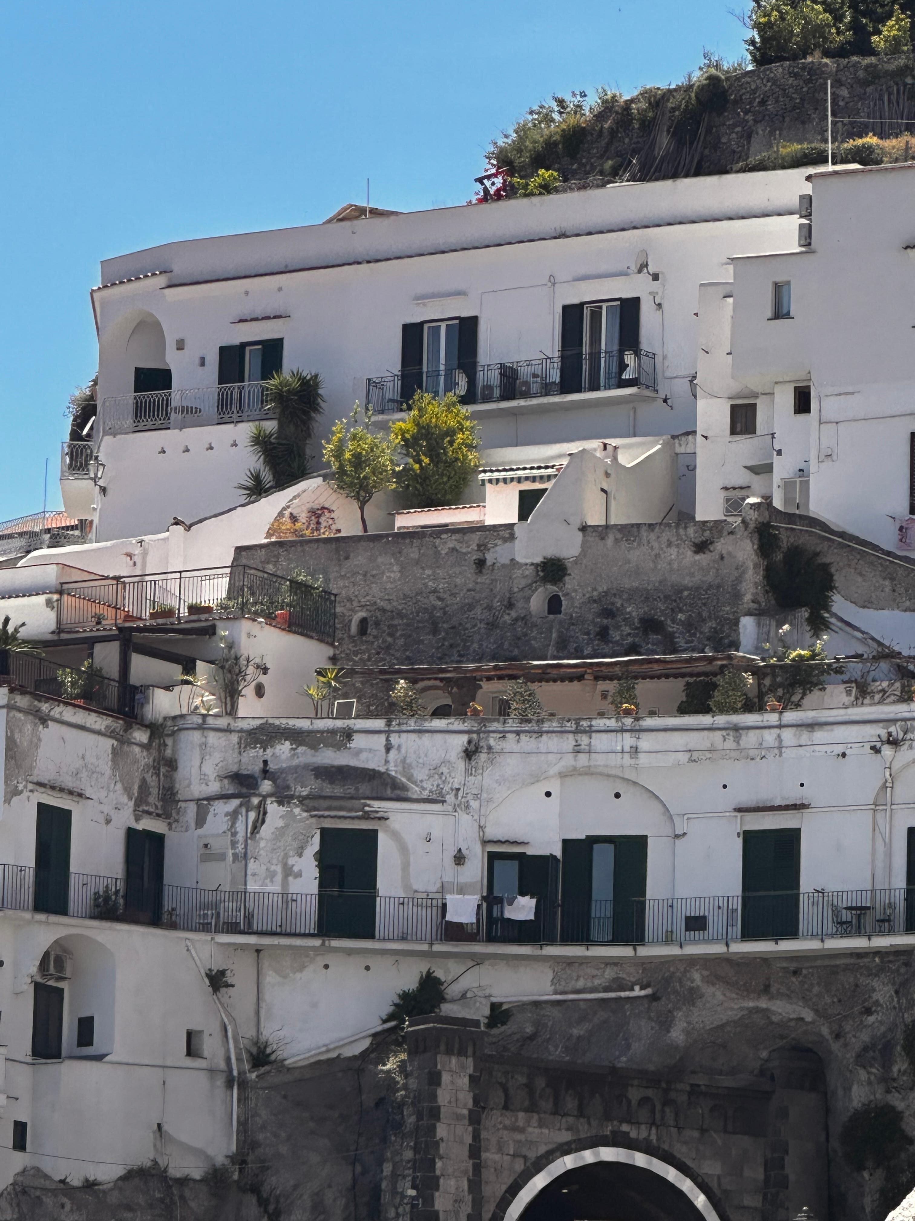 the top residence is Villa Torricelli (two balconies —on the left and middle)