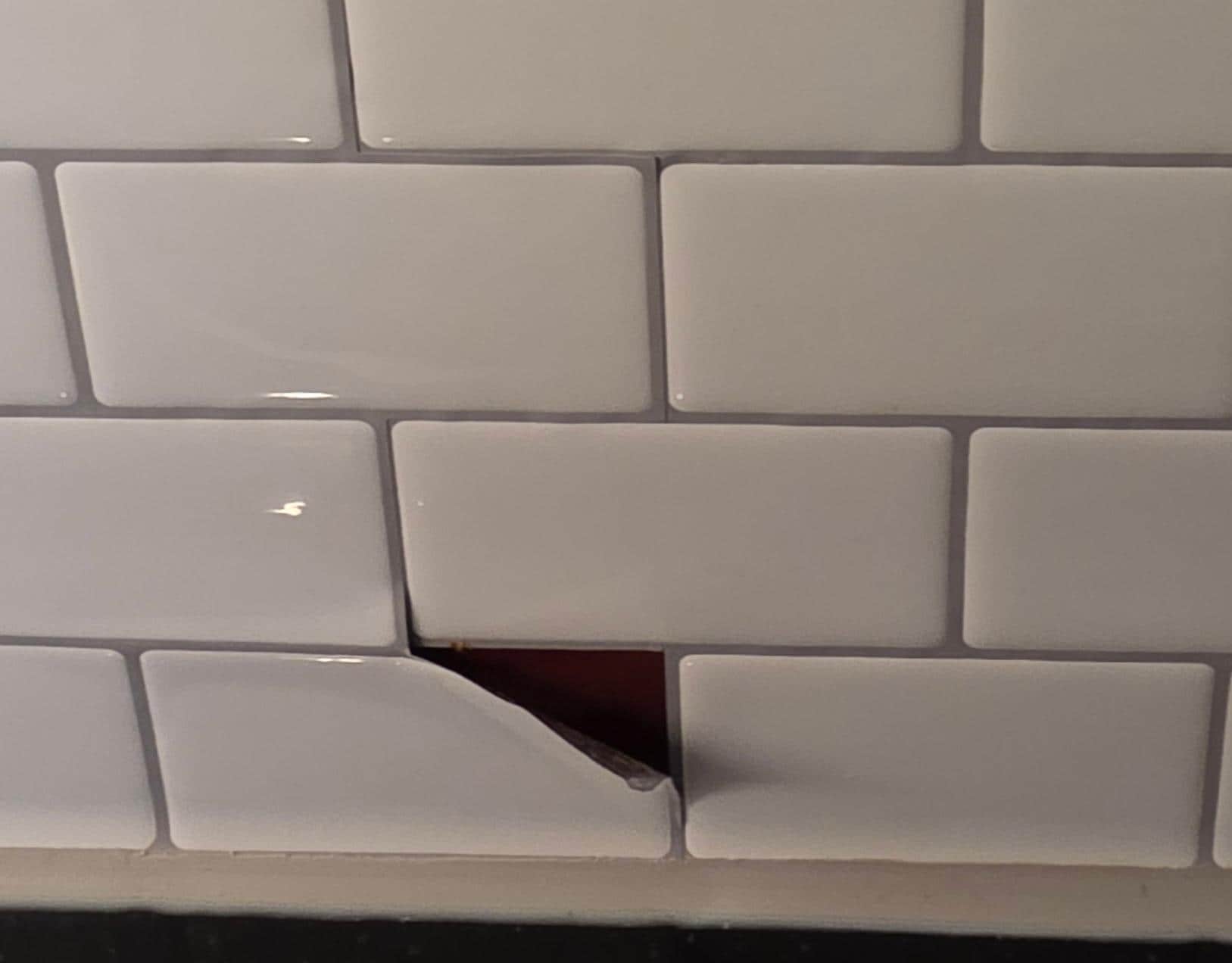 Glued on backsplash peeling off.   Made place feel cheap..
