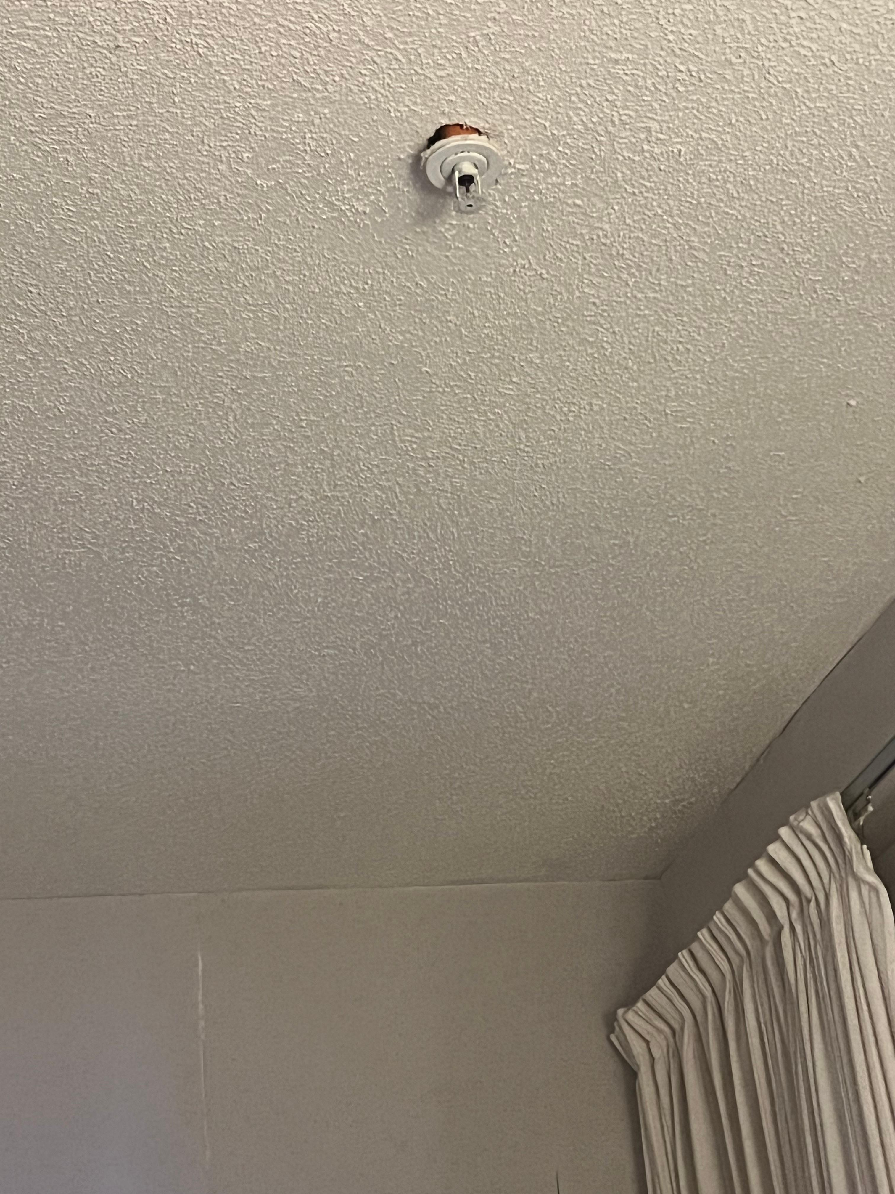 Fire sprinkler hanging out of ceiling
