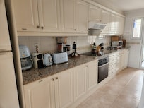 FULLY equipped kitchen, including olive oil, spices, coffee, tea, milk, wine and a basket of snacks! Even multiple types of coffee makers