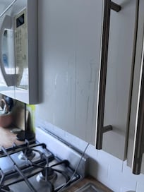 Dried liquid on the kitchen cabinets.