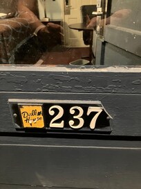 Broken number plate on door and old gross paint.