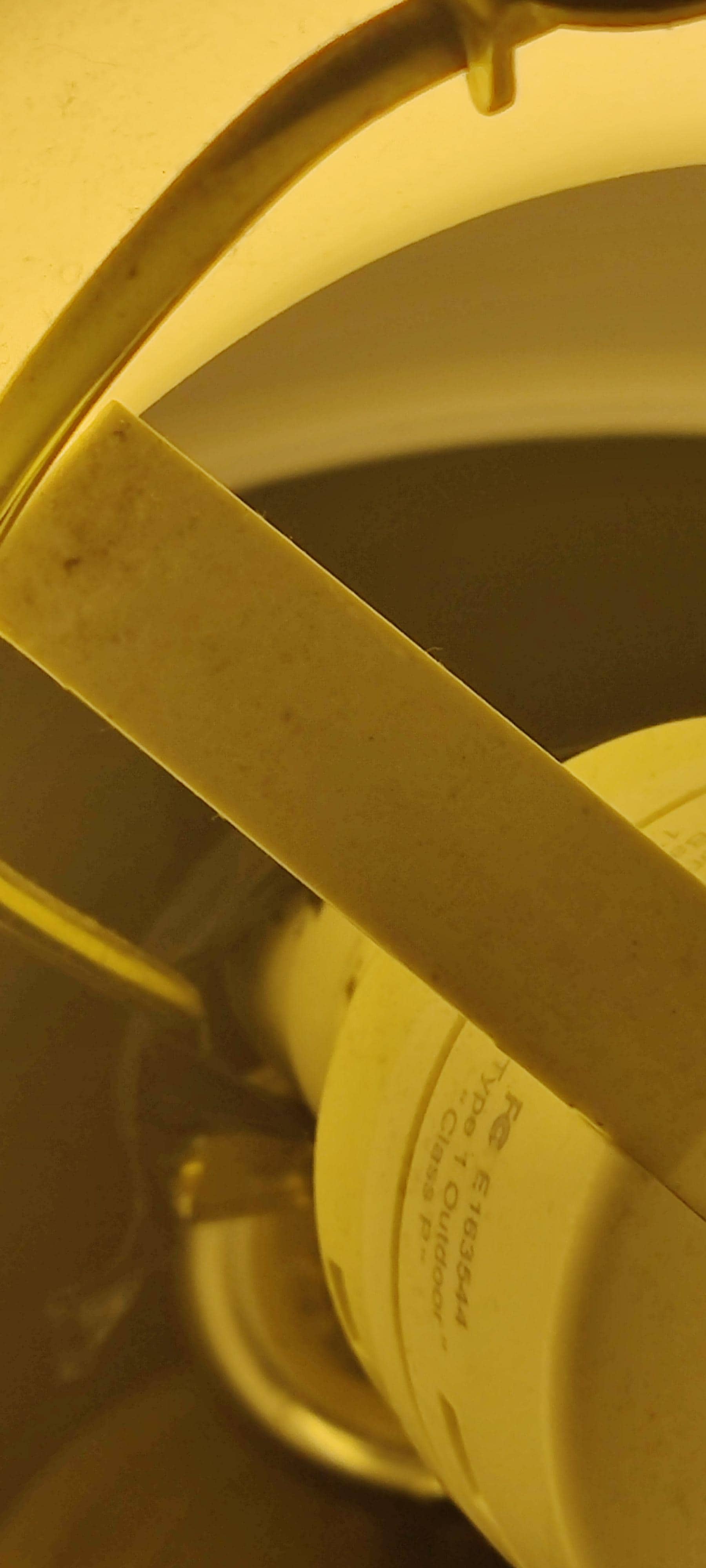 Closeup of lamp with electrical tape around base of bulb socket