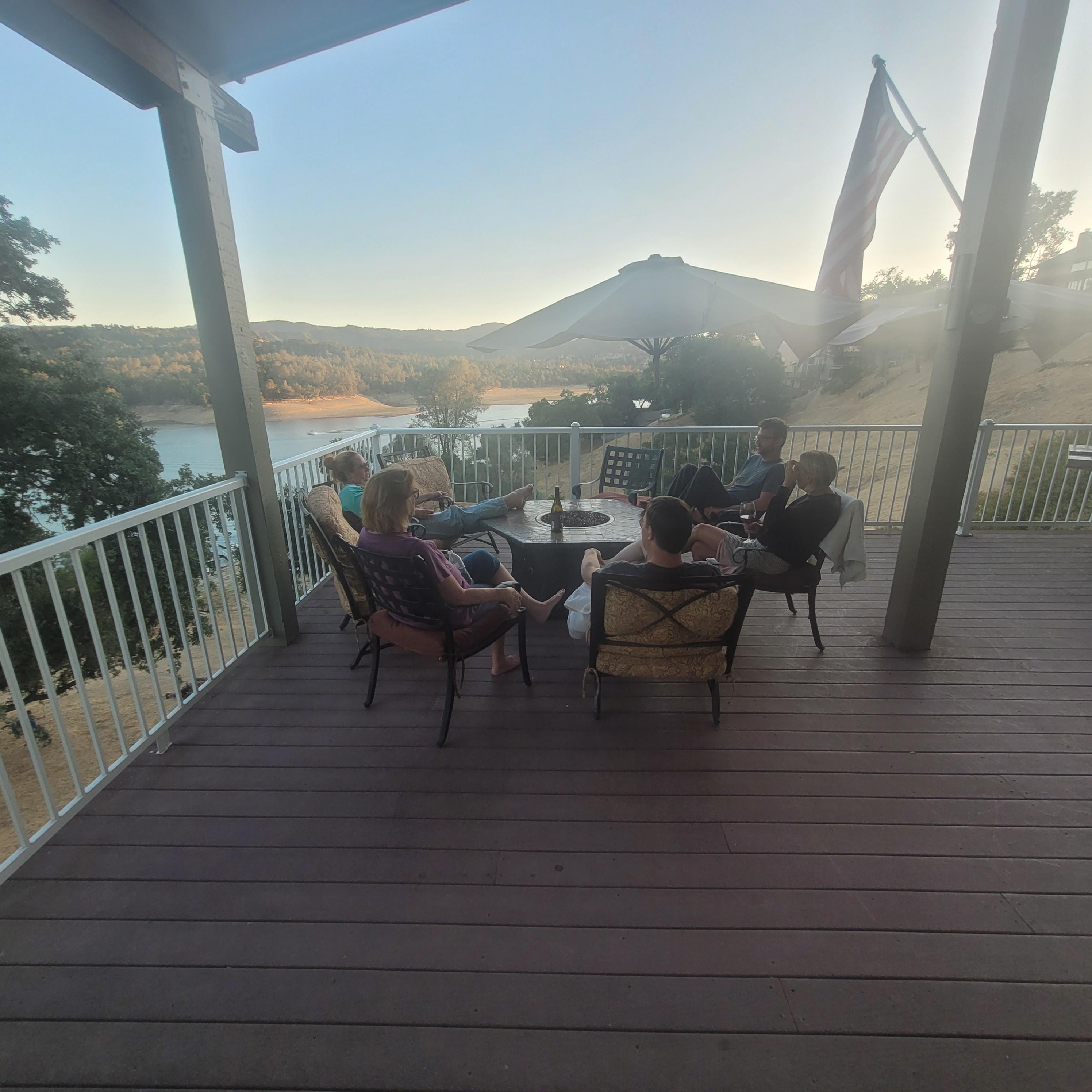 On the deck enjoying a glass of wine. 
