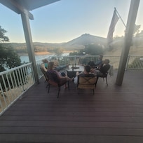 On the deck enjoying a glass of wine.