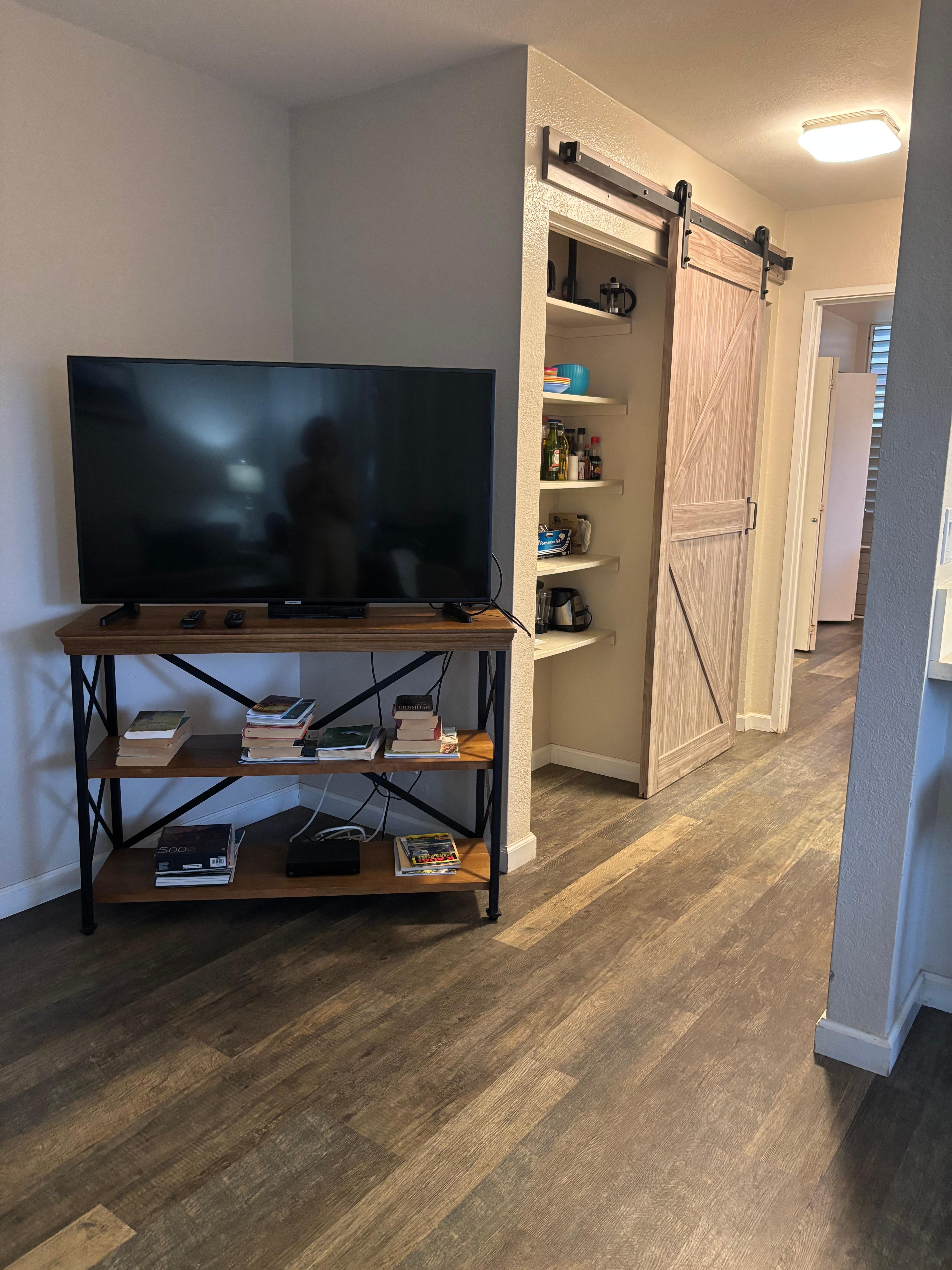 Pantry and washer/dryer behind barn door 