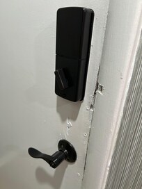 Front door handle is loose with chipped worn wood