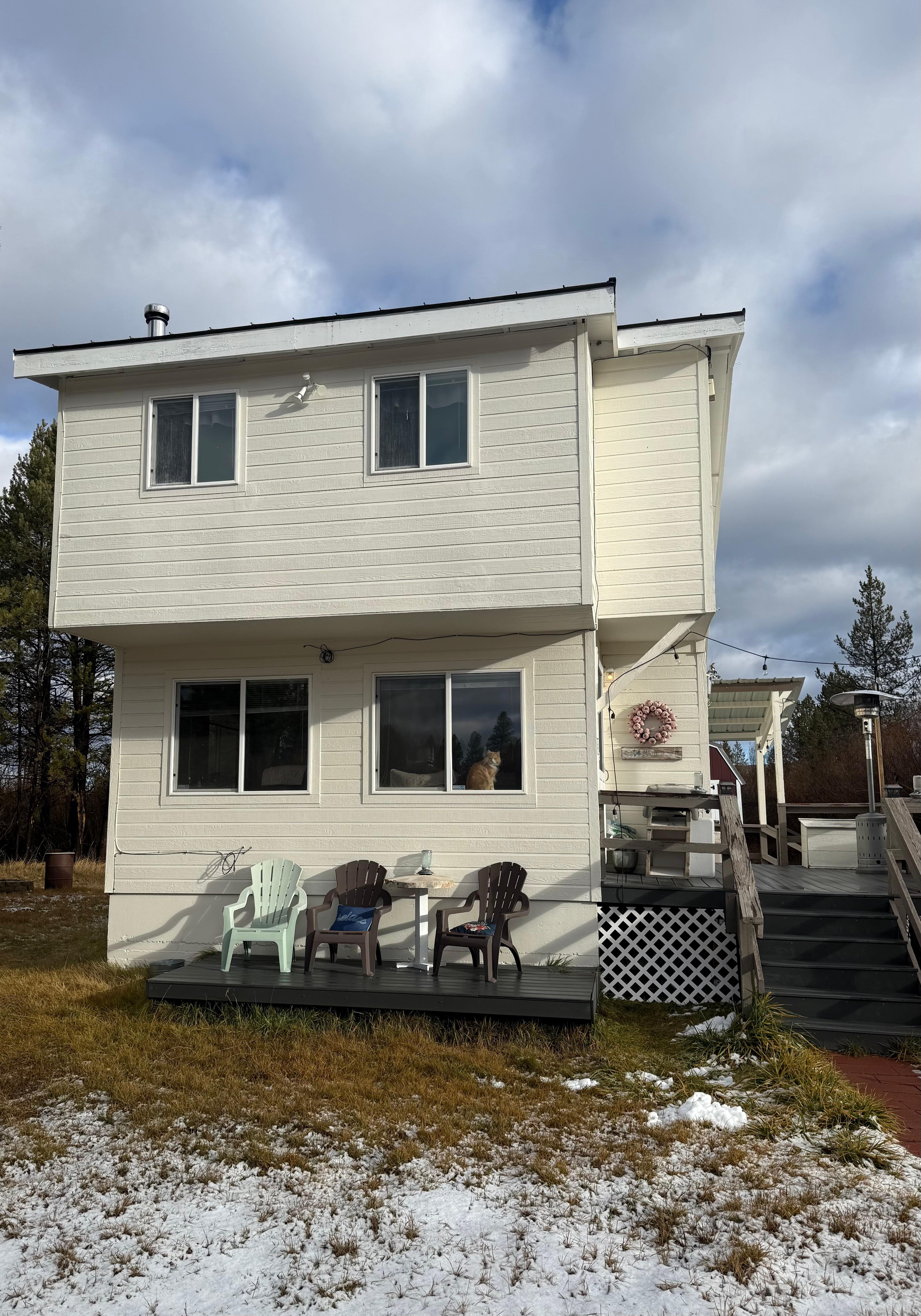 View of house from parking. Side deck and back deck visible. Plenty of sunshine and outdoor space to enjoy. 