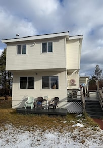 View of house from parking. Side deck and back deck visible. Plenty of sunshine and outdoor space to enjoy.