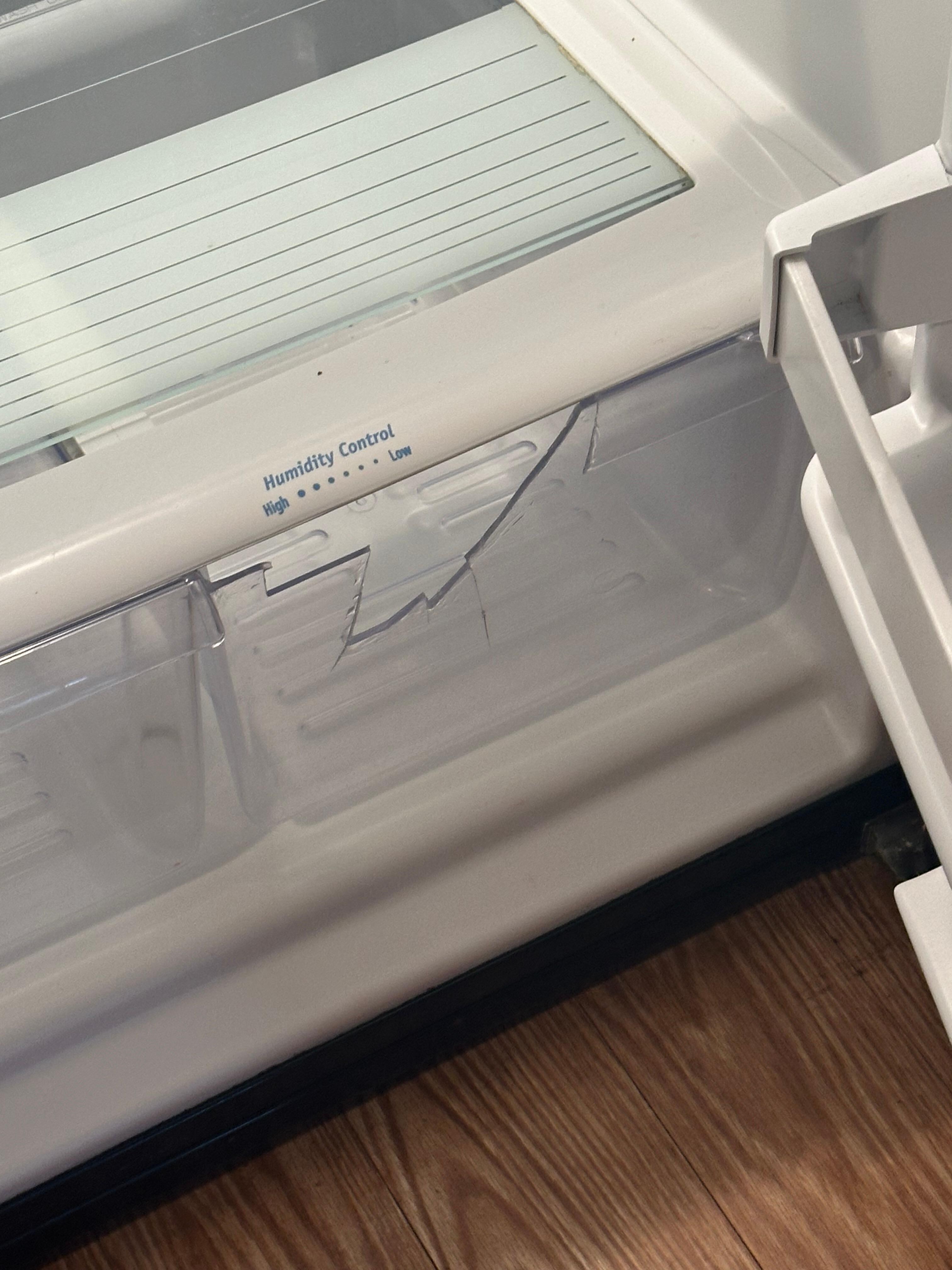 Cracked drawer in the refrigerator.