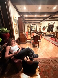 Lobby with warmth including comfy chairs and games to play.