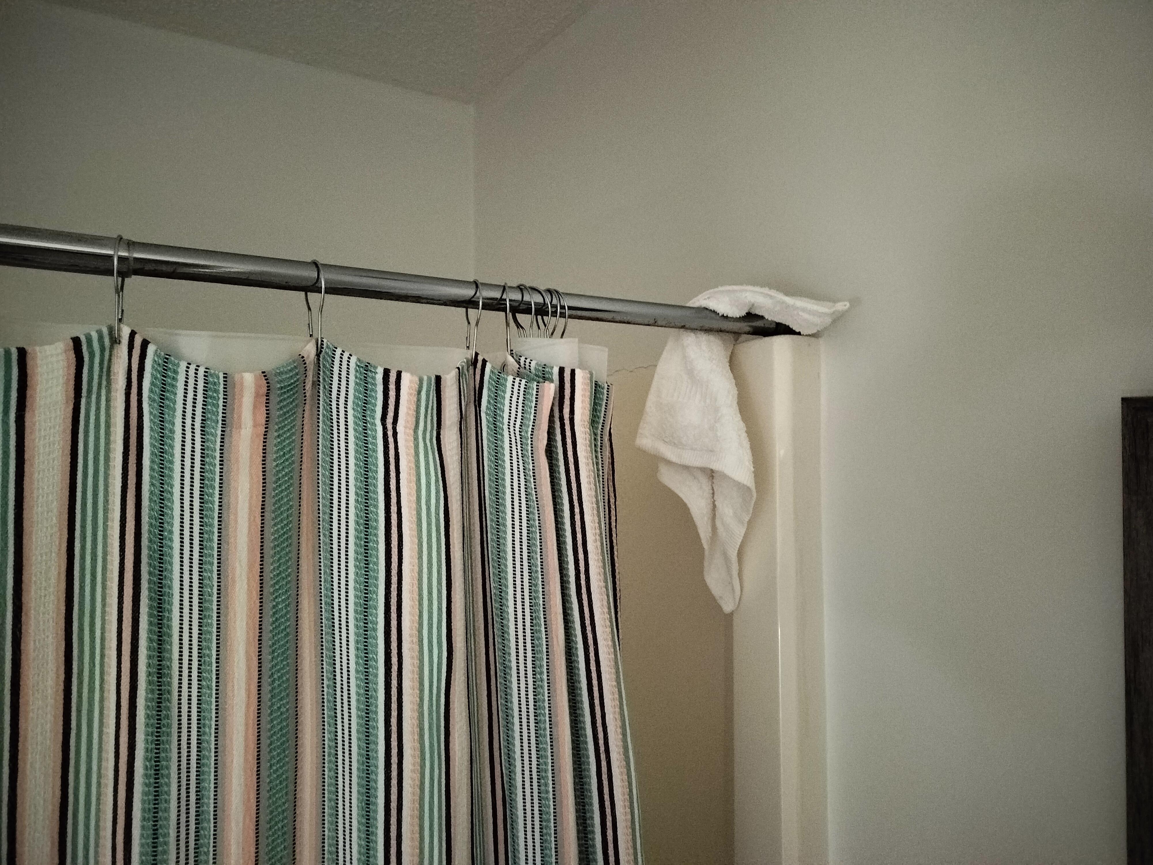 Cleaning rag left on shower curtain