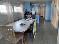 Dining room with kitchen in the background