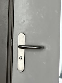 Sticky fingerprints and handprints around the door handle.