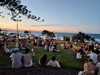 Listening to buskers at Main Beach at Sunset.