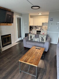 Living/kitchen area. Great for cooking and enjoying family time around the tv and fireplace