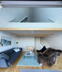 View of living area + loft bedroom