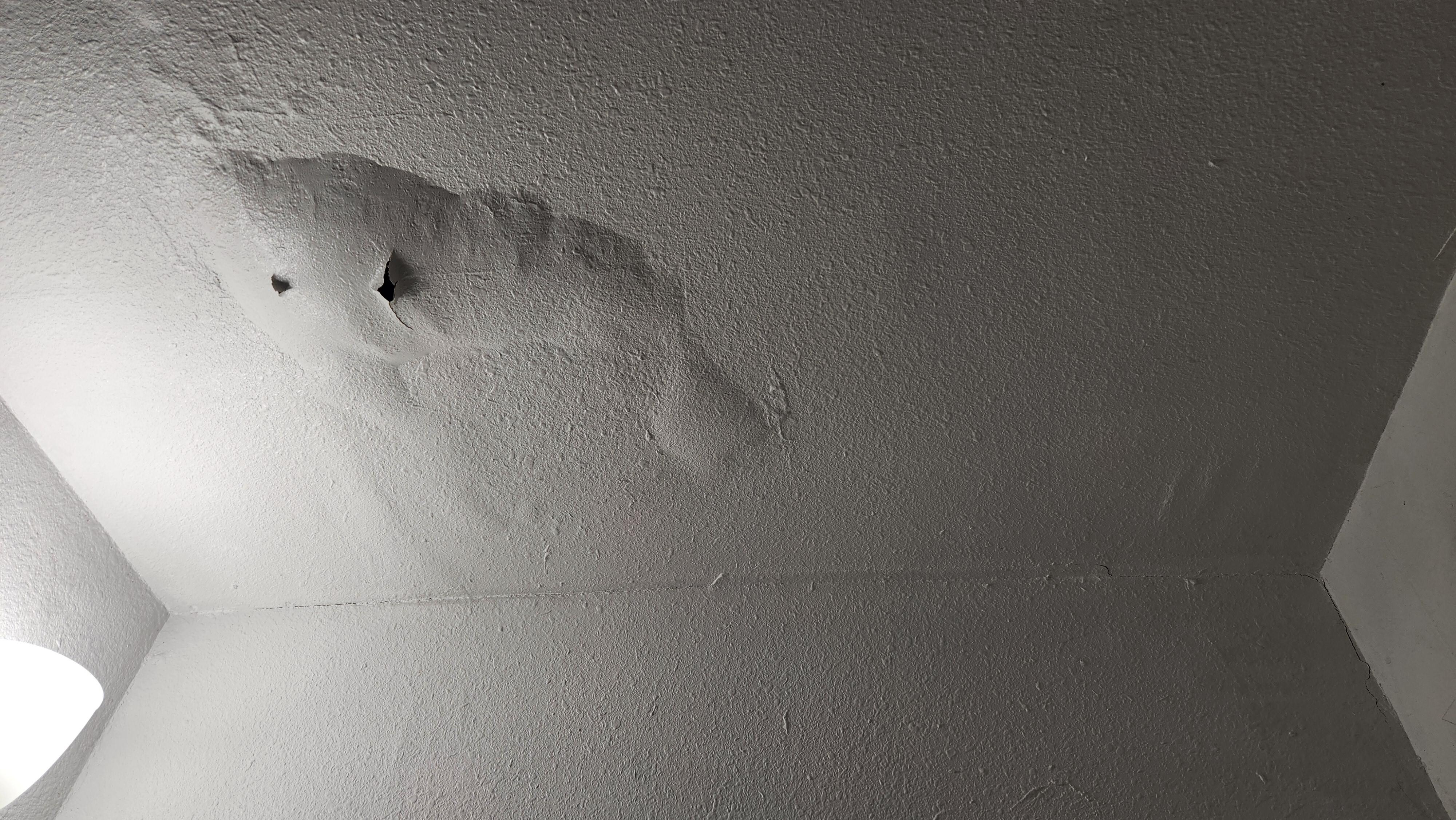 Bathroom ceiling w/ water damage that was not disclosed. This bathroom door was "accidentally" locked when we arrived at the house.