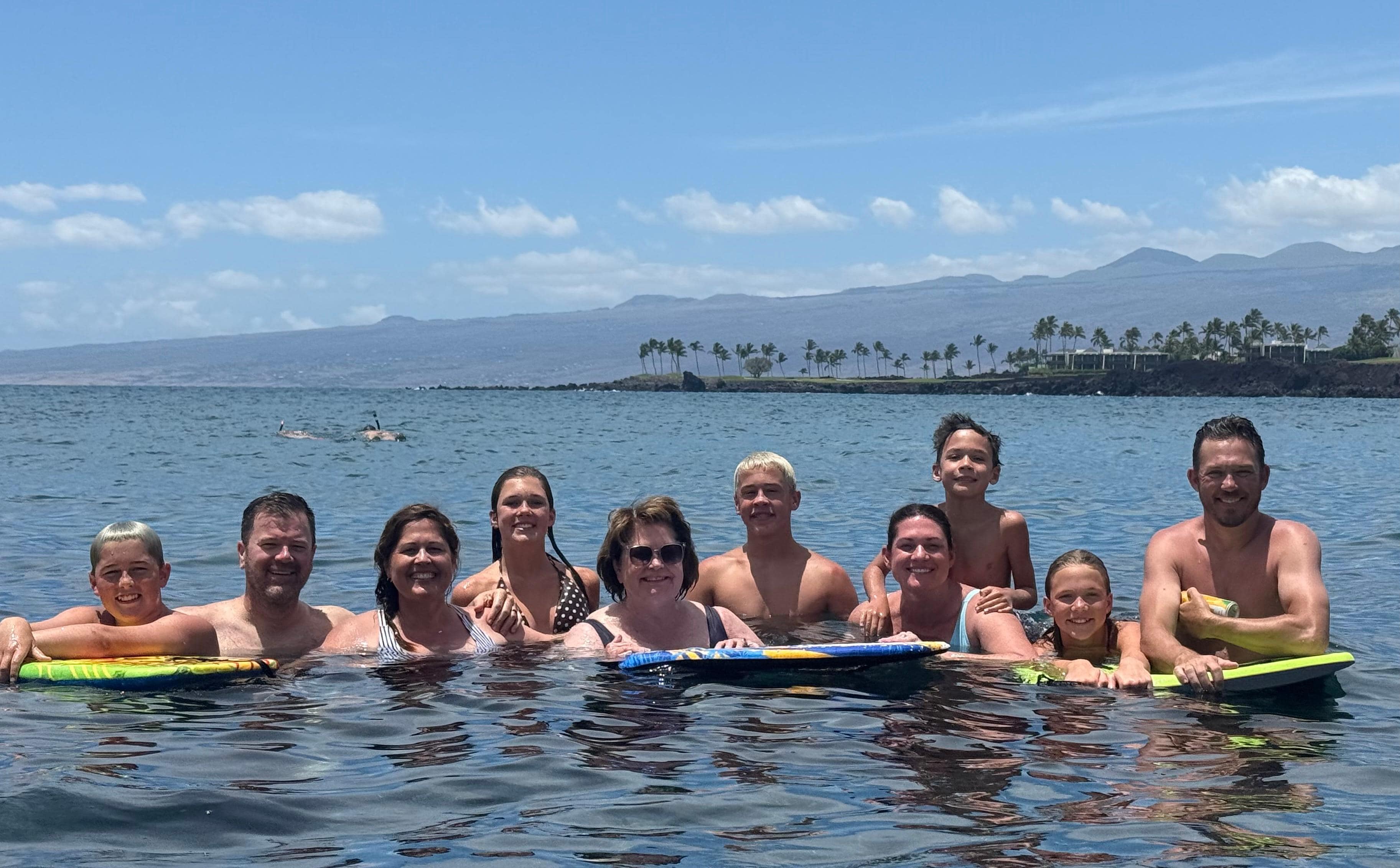 Our family in the water up the coast at the 49 Black Sand Beach
