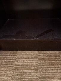 bottom shelf of bedside table