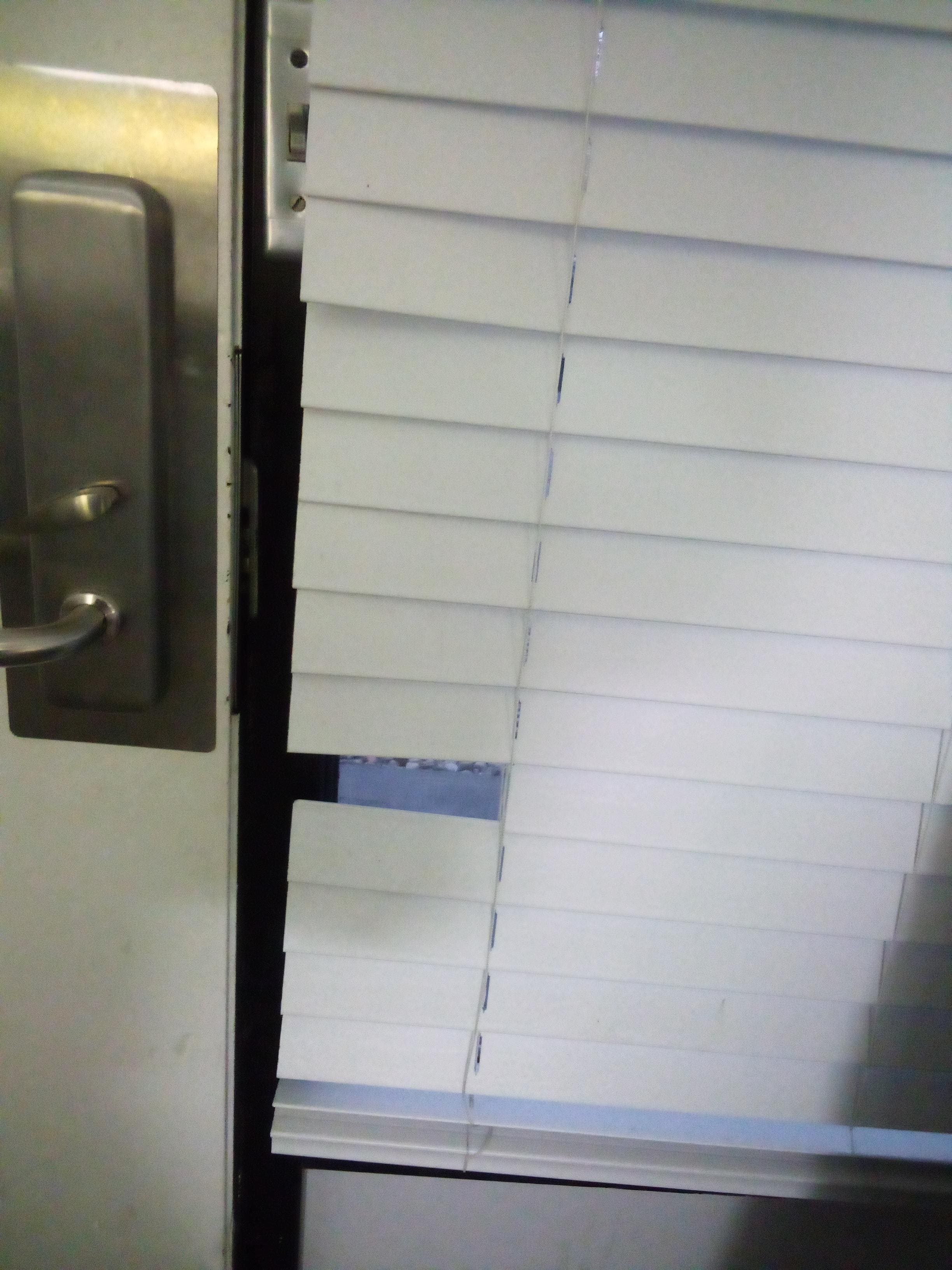 Ripped shades people peering in