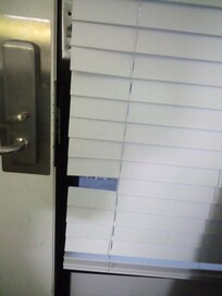 Ripped shades people peering in