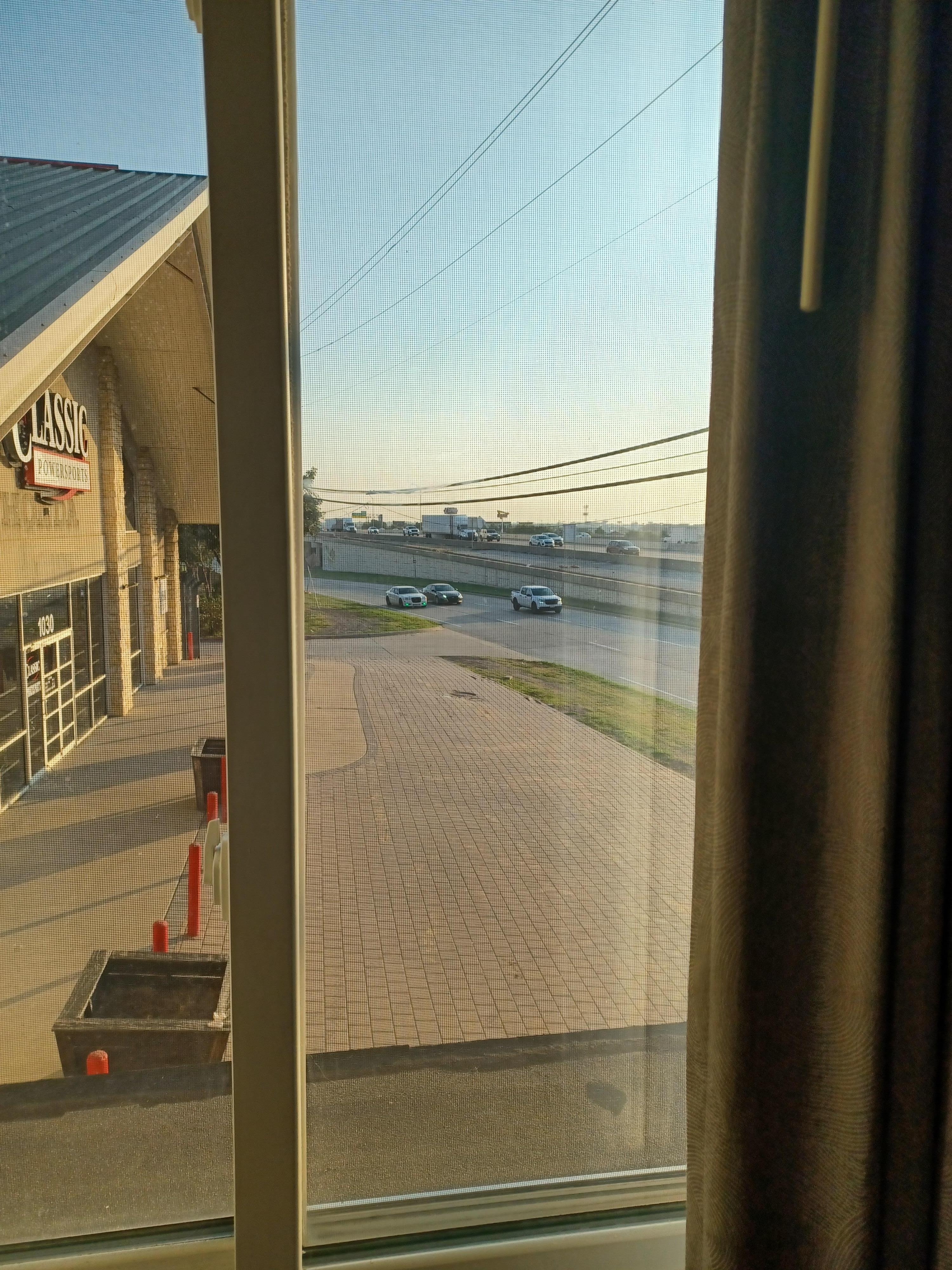 Side window right next to the bed.  Cars,  trucks,  bikes racing to merge into I-30. Bring ear plugs. 