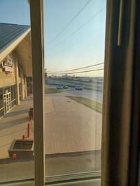 Side window right next to the bed. Cars, trucks, bikes racing to merge into I-30. Bring ear plugs.