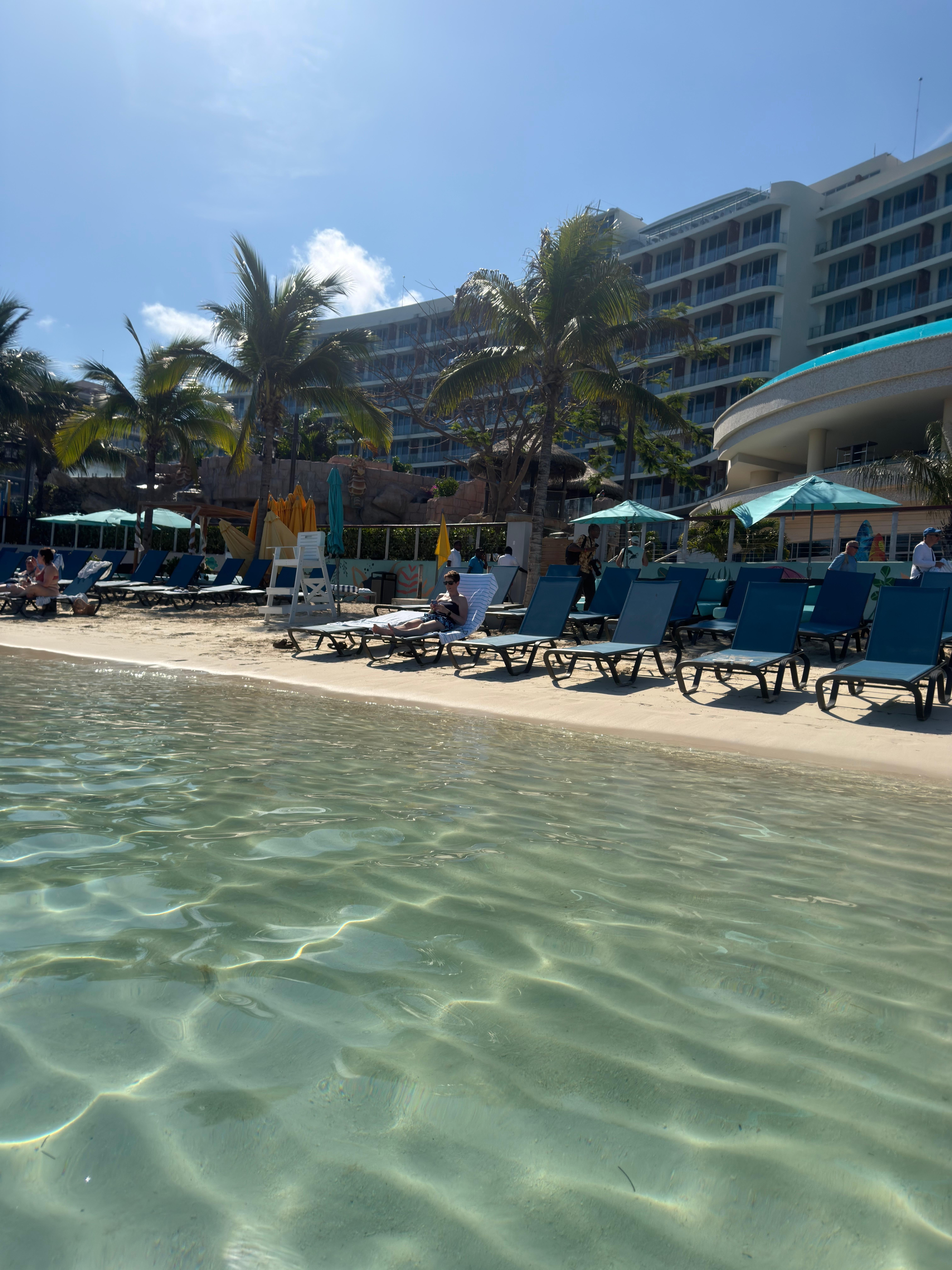 Facing resort from water. Cruise ships come in & the beach is open to those who buy the pass so it’s not as private as a beach as it seems. Gets extremely crowded & can be a struggle to find seats if needing more than one. This is before the arrival.