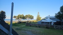 View to Ohope Beach from breakfast table. Walk across adjacent reserve space to sand and surf.