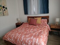 The large bedroom had nice lighting and two night tables.