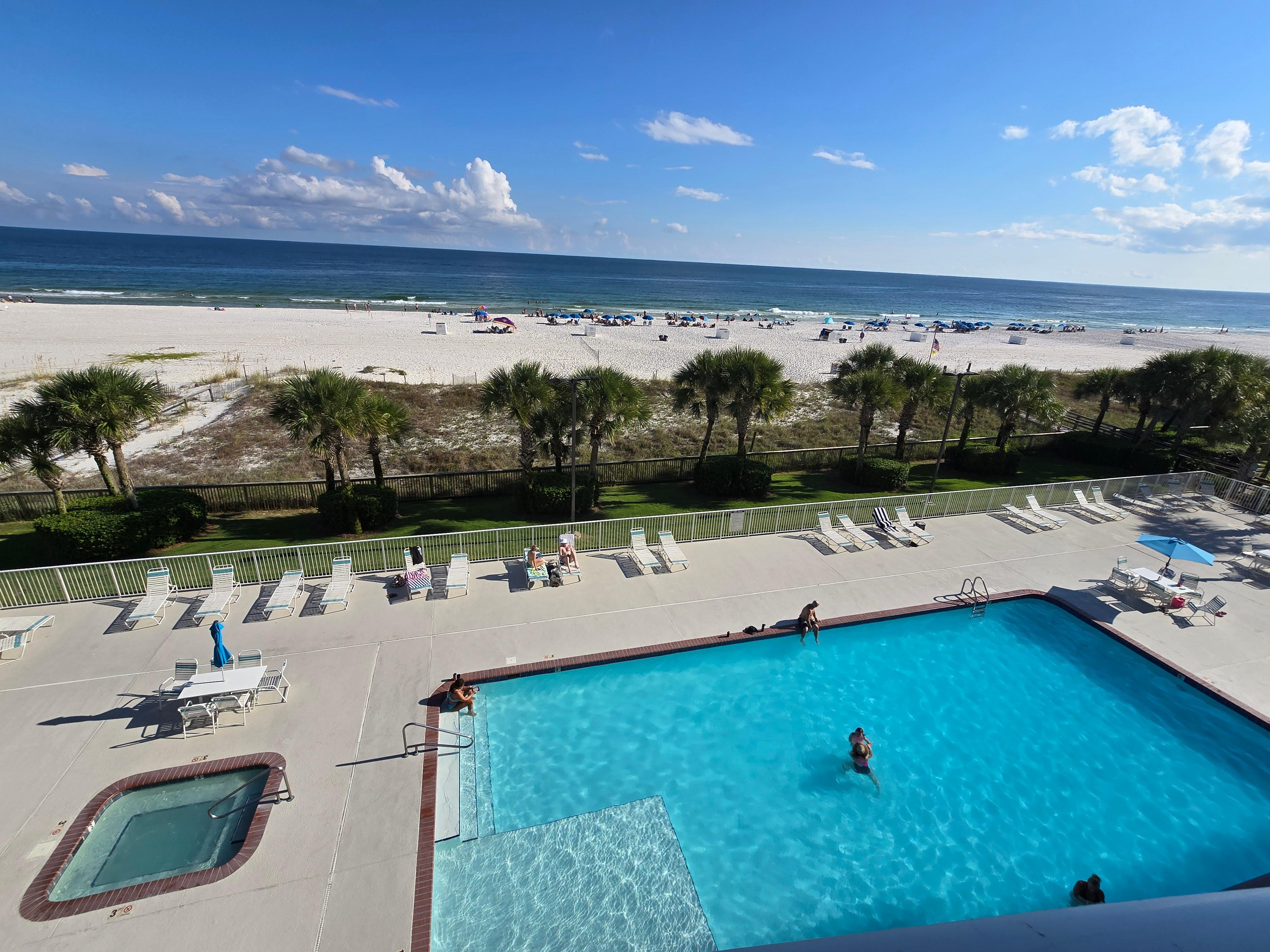View of pool and beach from balcony.