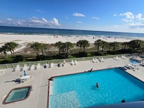 View of pool and beach from balcony.