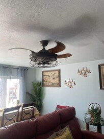 Cool industrial style ceiling fan with collapsible blades in living room