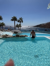 Poolside overlooking the ocean. That’s my hubby taking in the views!