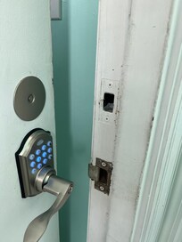 Front door. Deadbolt removed and plate covering hole.