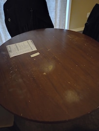 Dining table and chairs very old, stains, wood chipped, someone literally took a fork and put holes in it