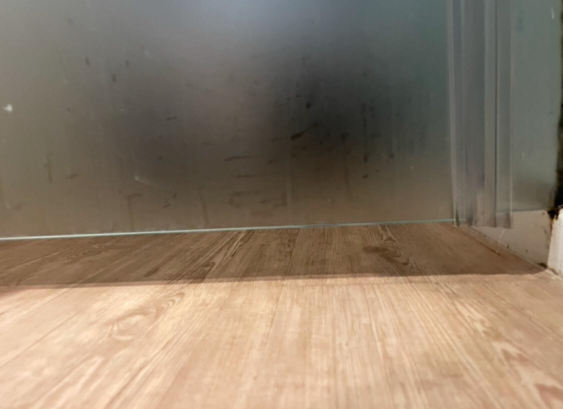 Glass partition for toilet open at the bottom, offering no privacy (not shown on hotel description)