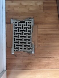 This is the floor air vent located in the narrow walkway around the kitchen island. Instead of being secured properly, it was held in place with duct tape. Because it sits directly in the walking path, you have to physically step on it.