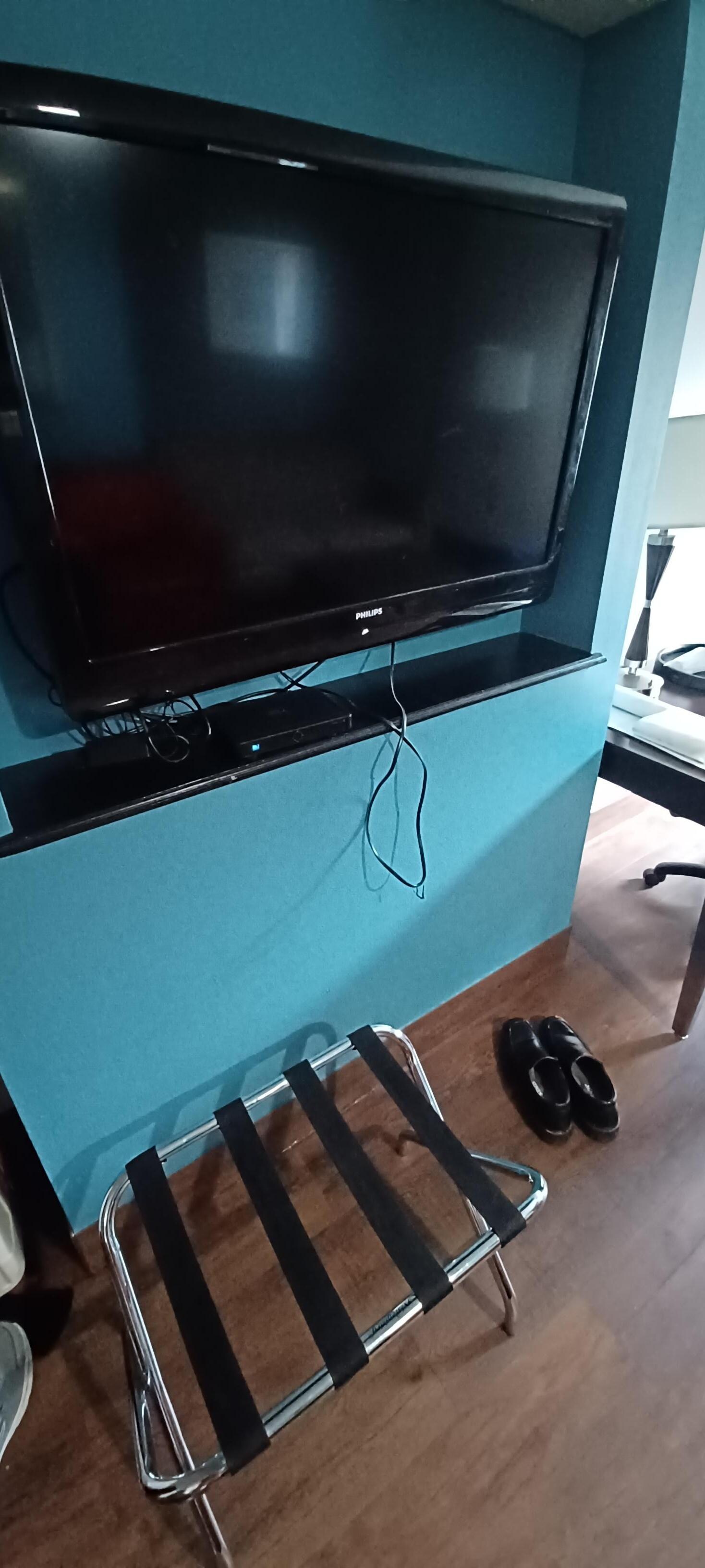 TV was barely attached to the wall. We didn't dare try to turn it toward the bed.