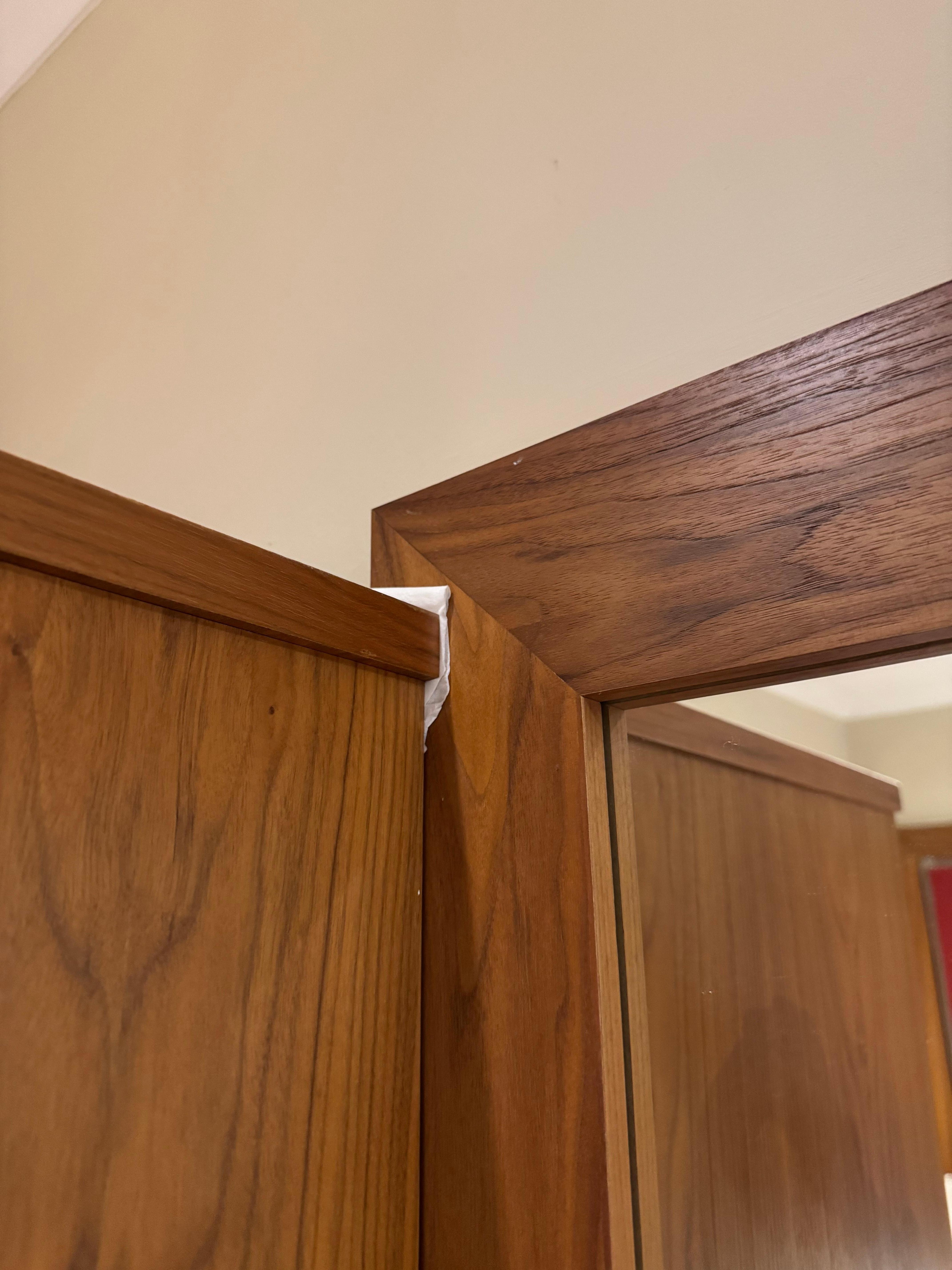 Wardrobe ill fitting and paper towel used to ad it against the mirror frame