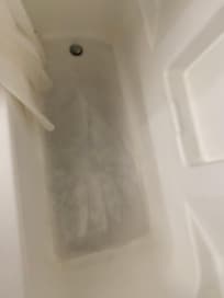 Second room: dirty stained tub.