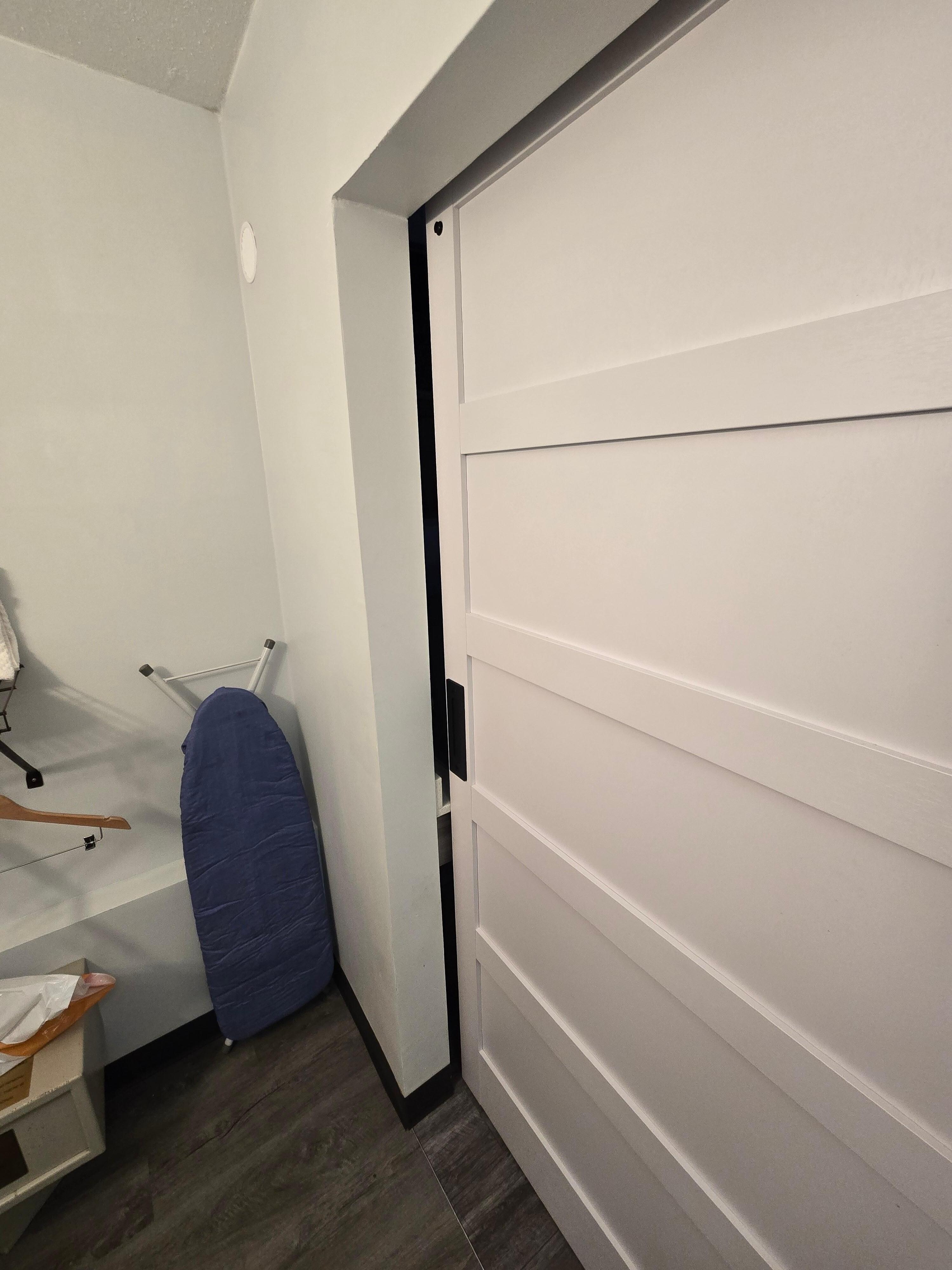Sliding bathroom door improperly installed & would not close properly. 