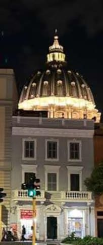The street entrance to the apartment with the dome of St Peter's basilica in the background.