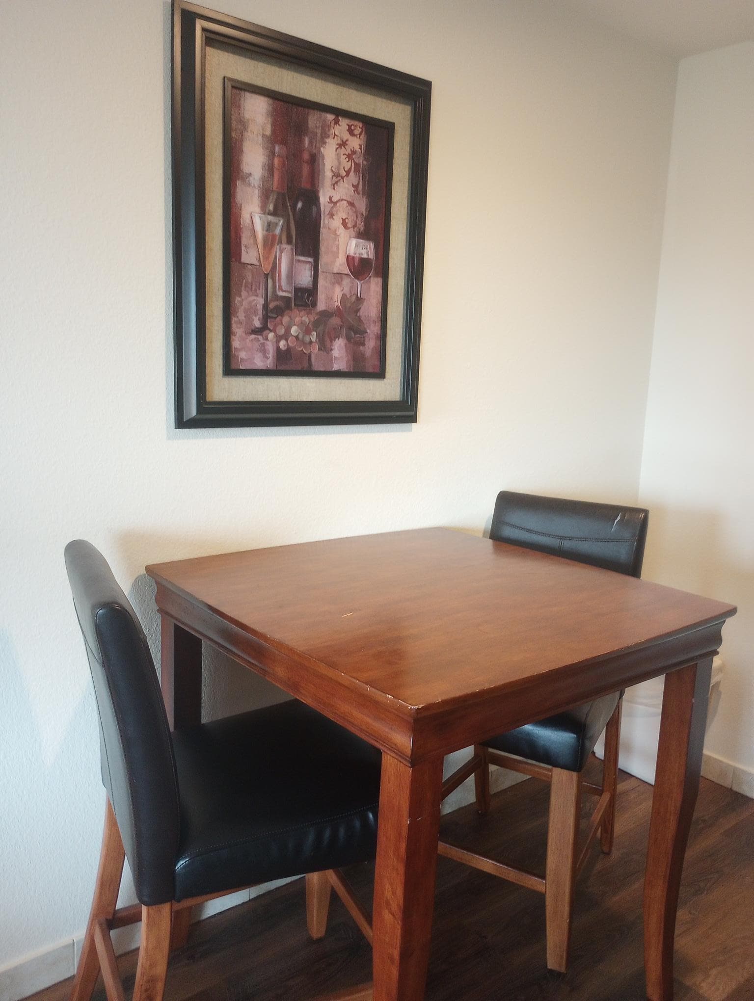 A high table and two chairs in our room.