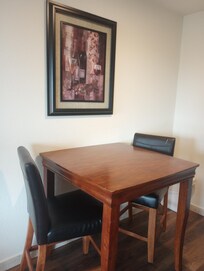 A high table and two chairs in our room.