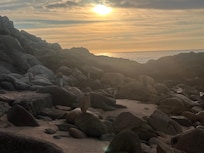 The rock side of the beach near the condo