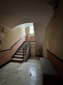 wide set of stairs in the building leading up and down into the ground floor