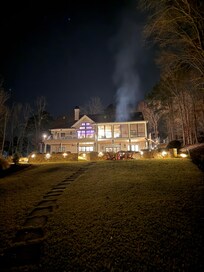View from the backyard in the evening; the fire pit with Adirondack chairs was used every night.